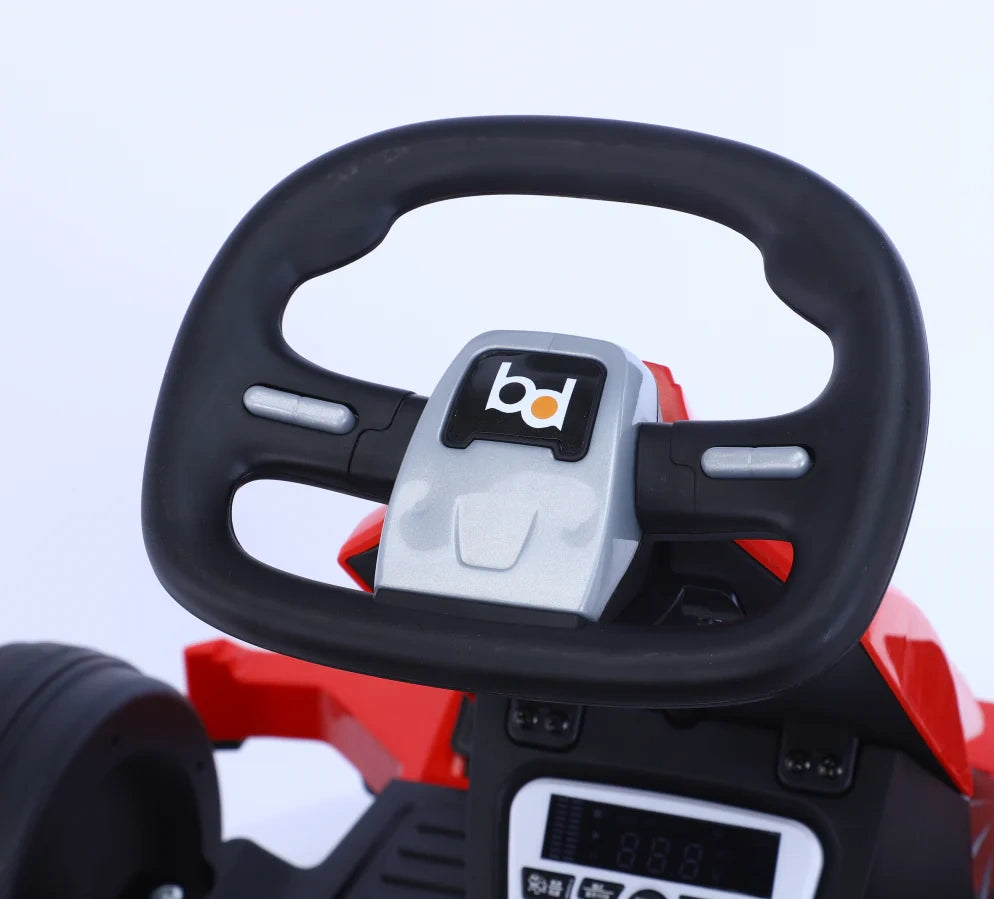 Steering wheel of a toy car with a visible brand logo on a light blue background