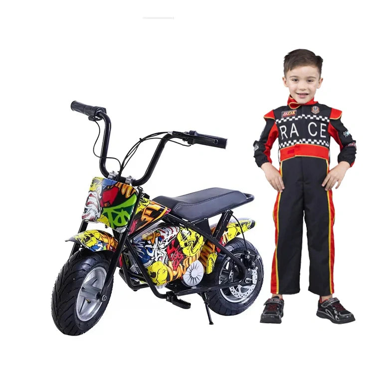 Child in a racing suit standing next to a colorful toy motorcycle on a white background