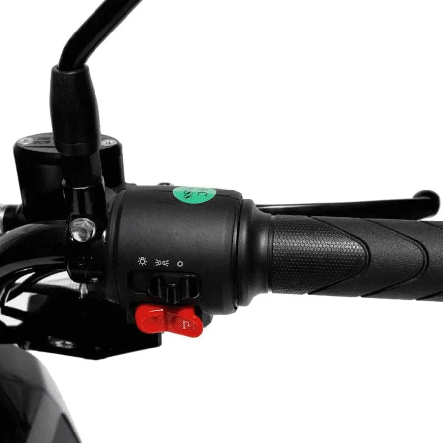 Close-up of a motorcycle handlebar with control buttons on a white background