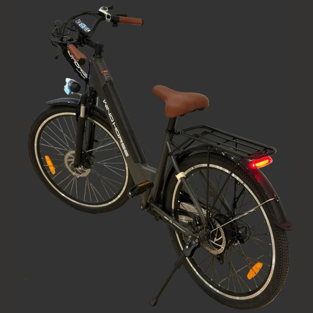 Electric bicycle with brown seat and black frame on a dark background