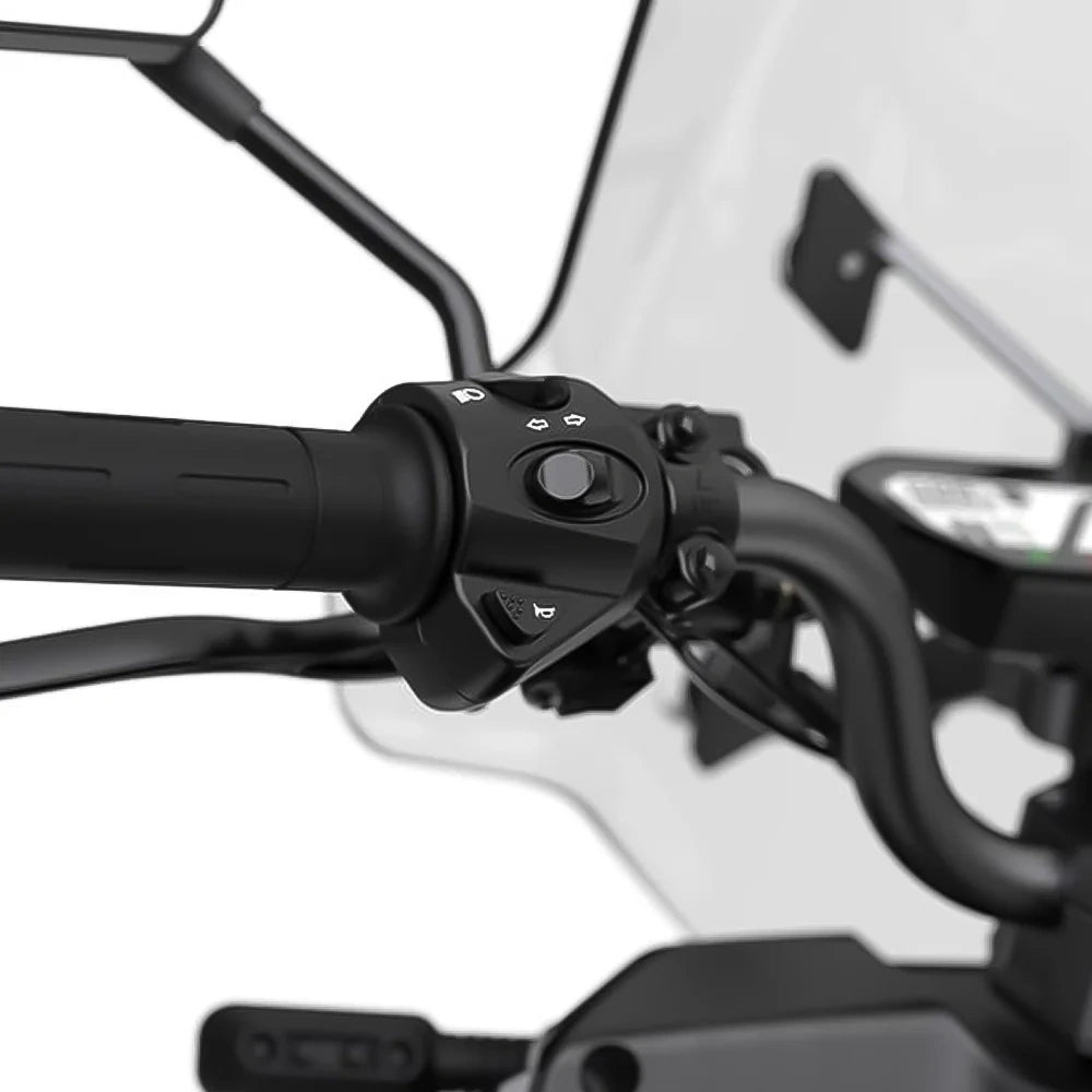 Close-up of motorcycle handlebar controls with a blurred background