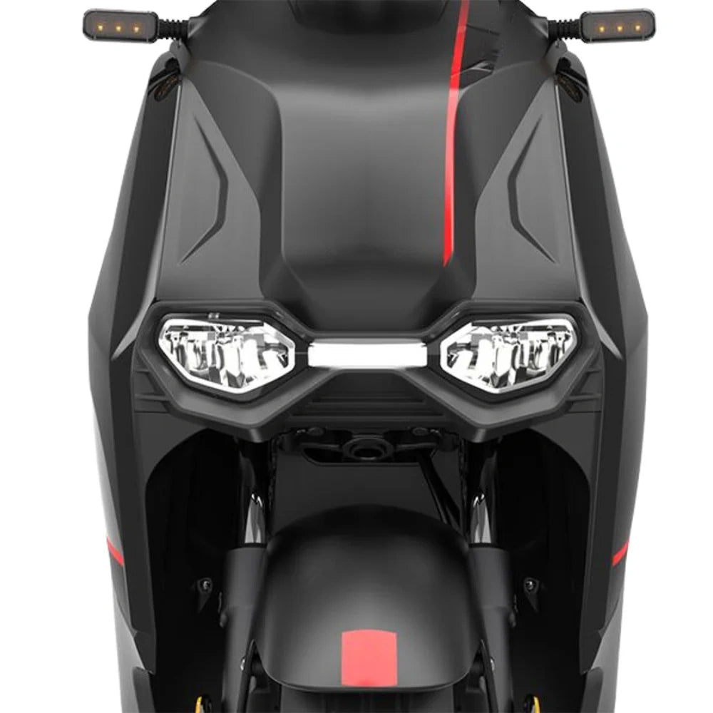 Close-up of a black scooter with red accents on a white background