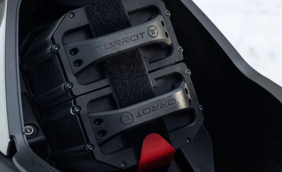 Black motorcycle foot pegs with red accent on a motorcycle seat