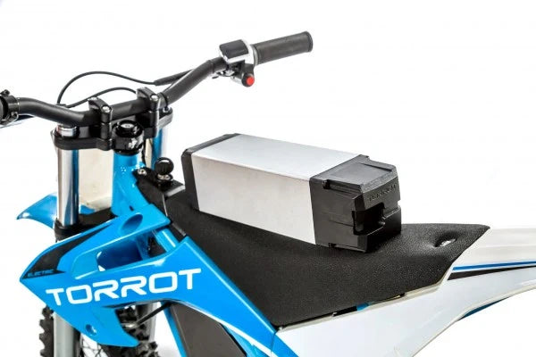 Blue and white dirt bike with a black and white battery pack attached to the seat