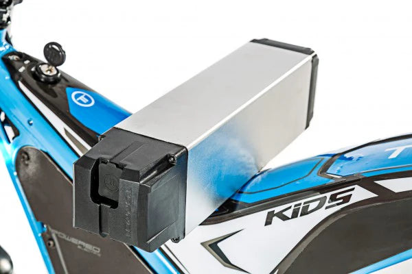 Close-up of a blue and black children's bike with a battery pack attached.