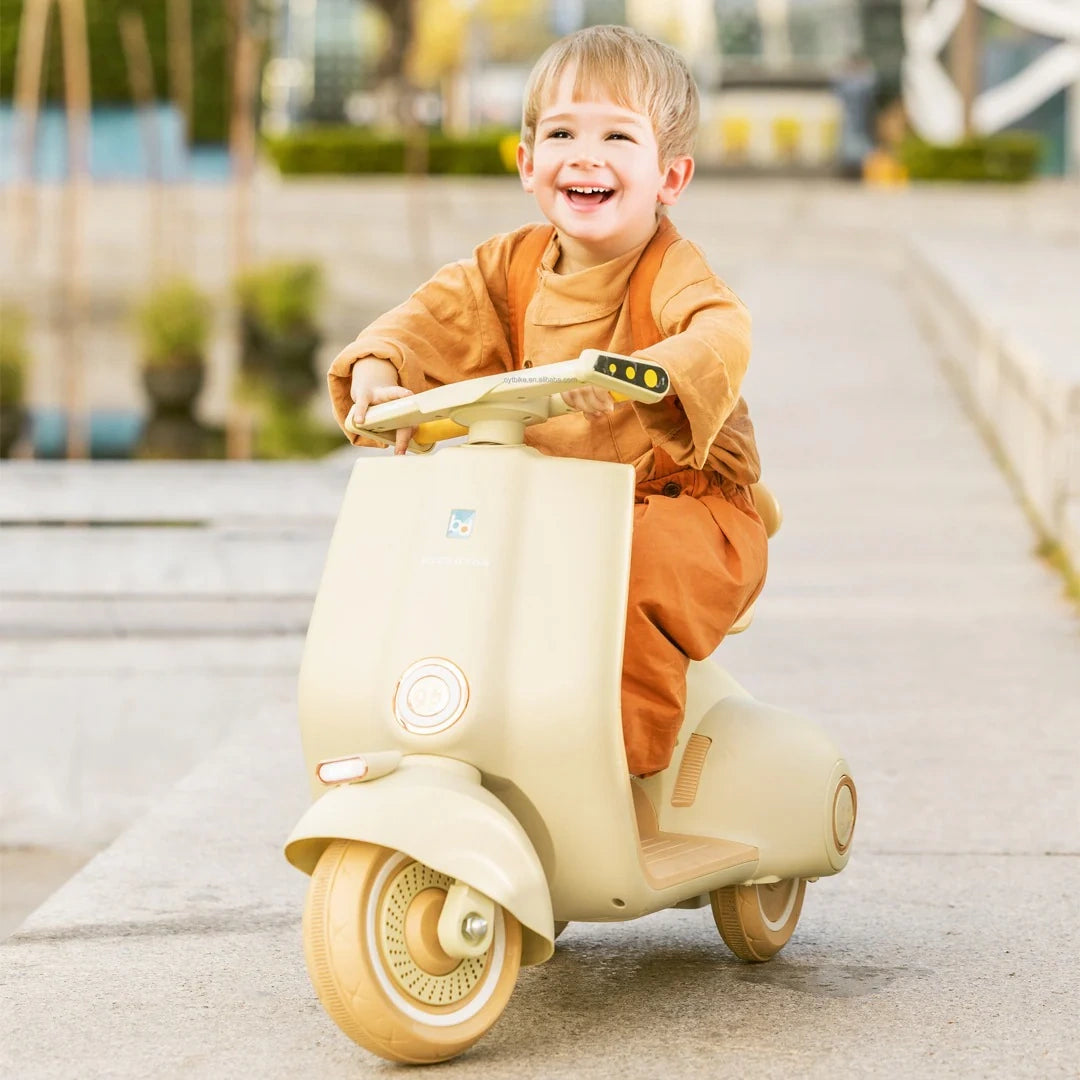 Child riding a beige toy scooter outdoors