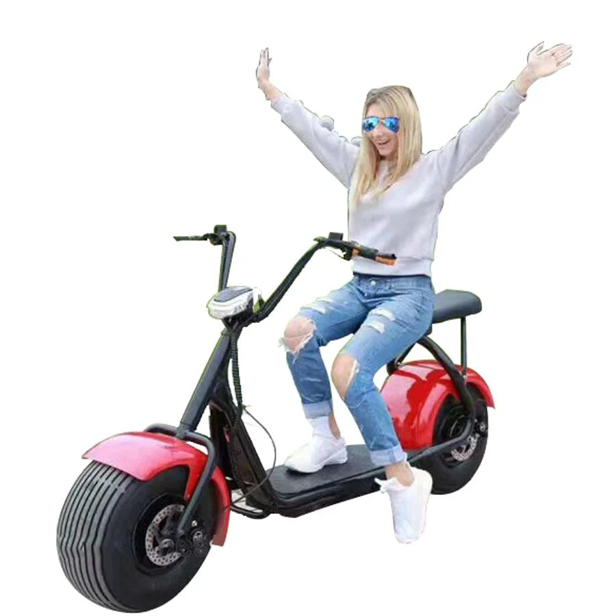 Person sitting on a red and black electric scooter with arms raised against a white background