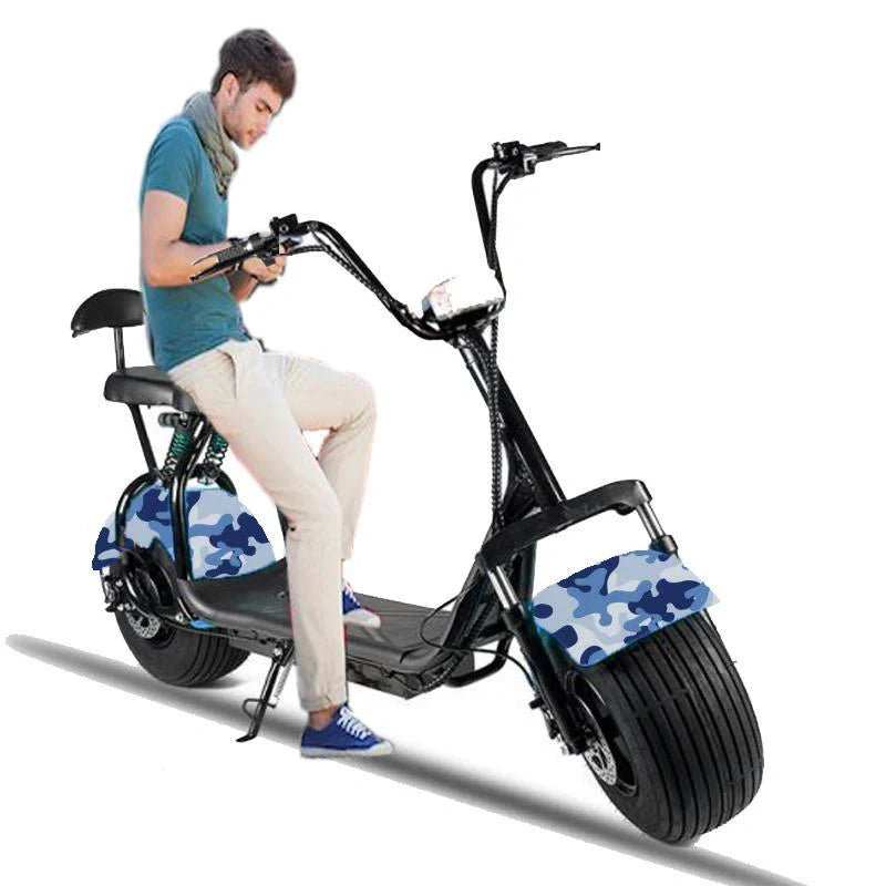 Person sitting on a black electric scooter with blue camouflage design on wheels against a white background