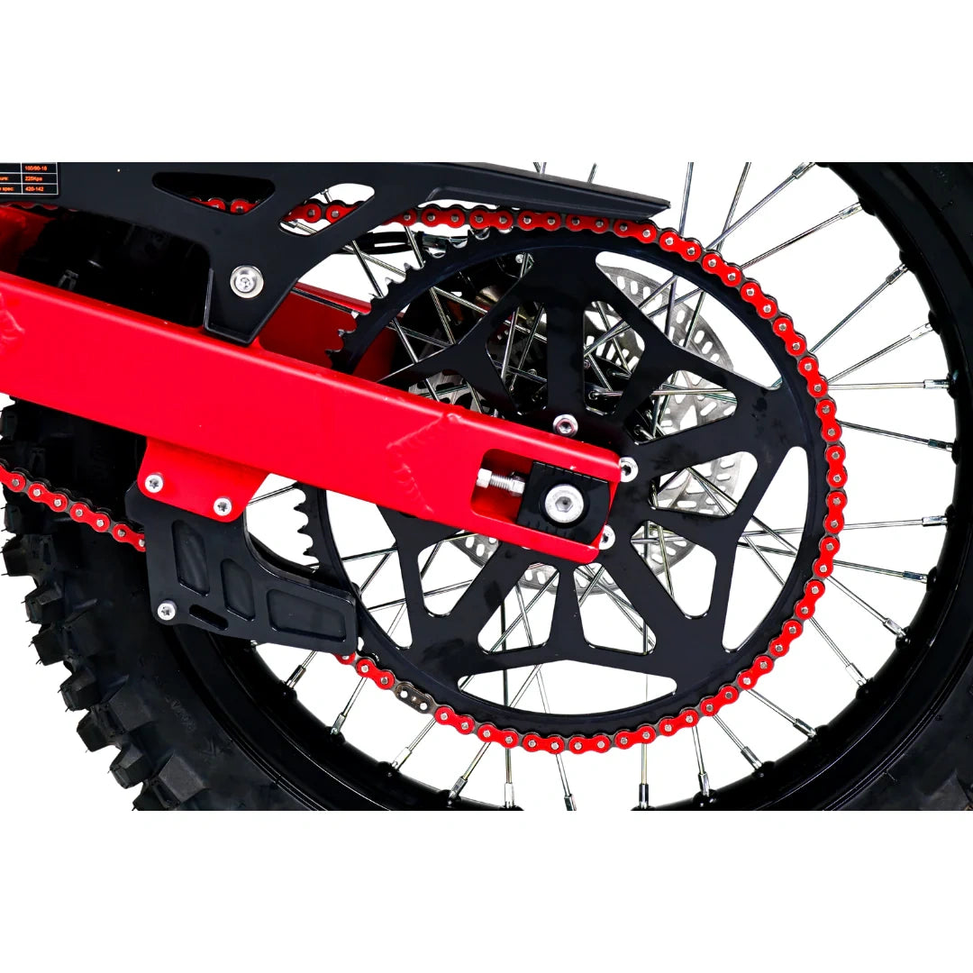Close-up of a motorcycle wheel with red chain and black sprocket on a white background