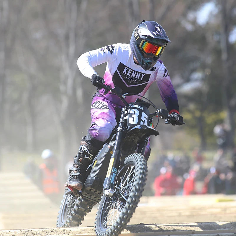 Motocross rider in action on a dirt track with blurred background