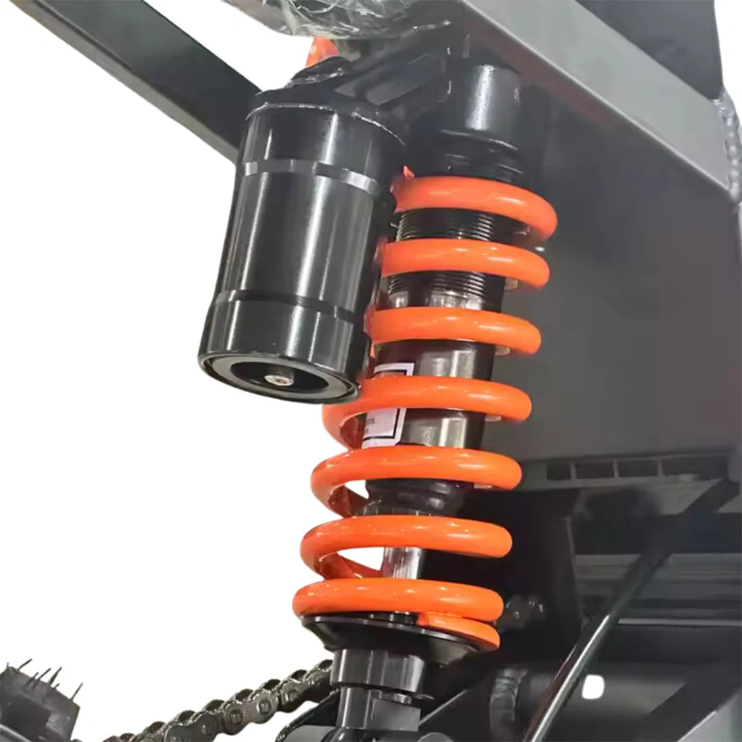 Close-up of a motorcycle shock absorber with orange springs on a white background