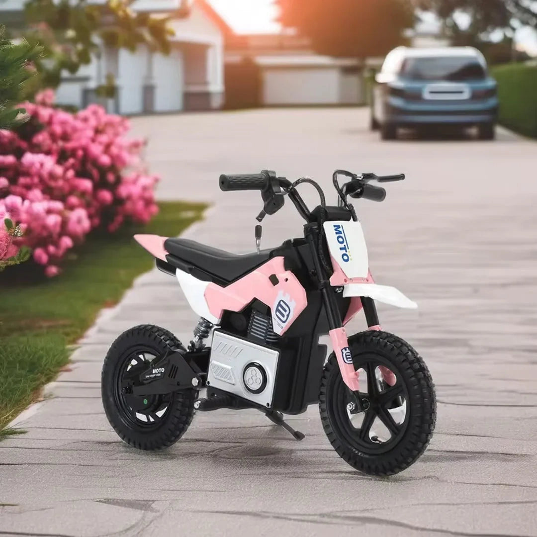 Pink and black children's electric bike on a driveway with flowers and a car in the background