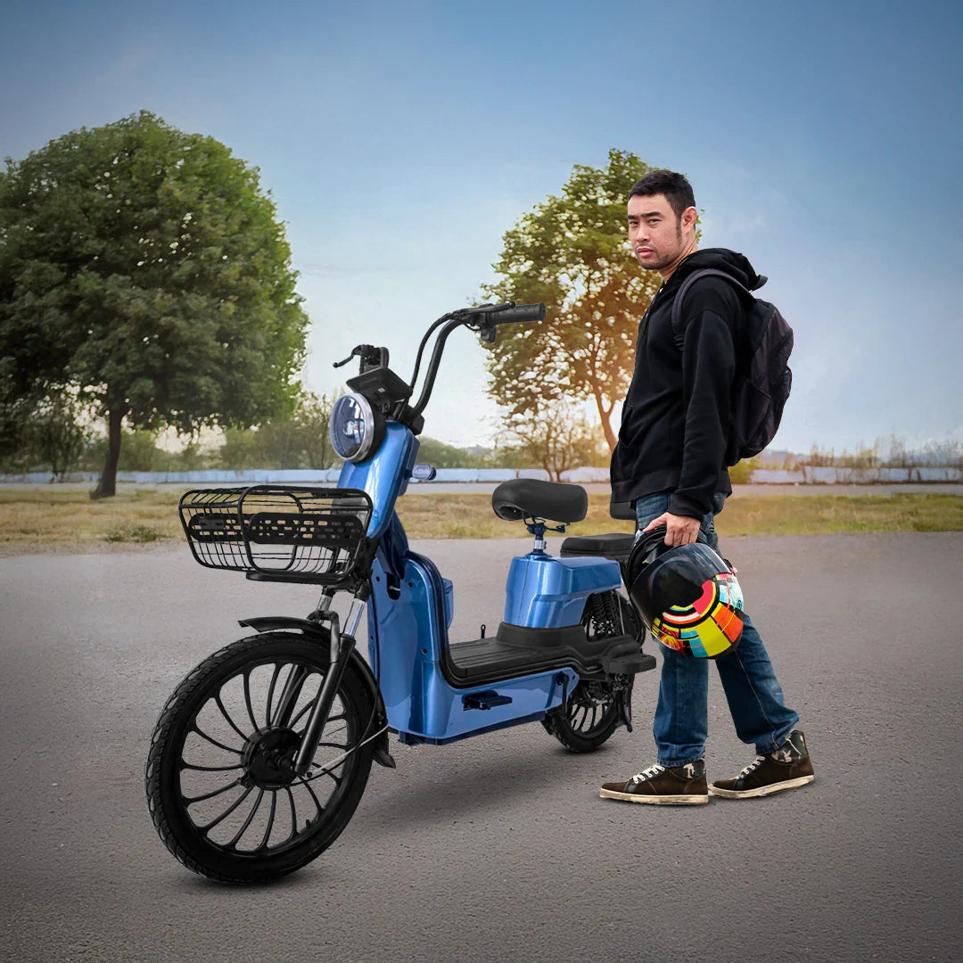 Man standing next to a blue electric bike on a road with trees in the background