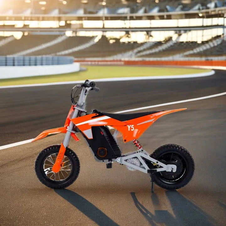 Orange and black dirt bike on a racetrack with stadium in the background