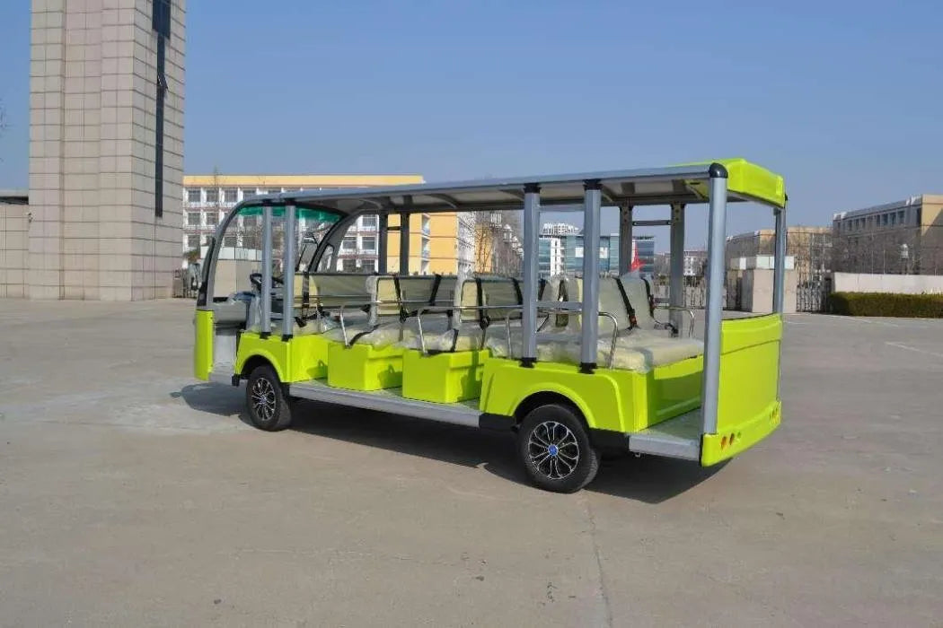 Green electric sightseeing car on a concrete surface with buildings in the background