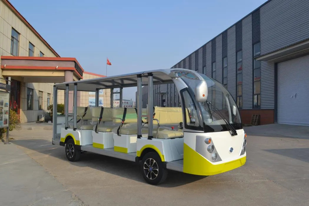 Small electric vehicle with a yellow and gray design parked in front of a building.