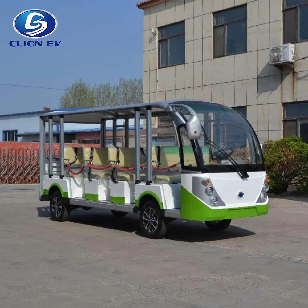 Small electric bus with green and white design parked in front of a building.