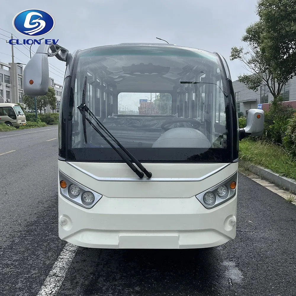 White electric bus on a road with 'ELION EV' branding.
