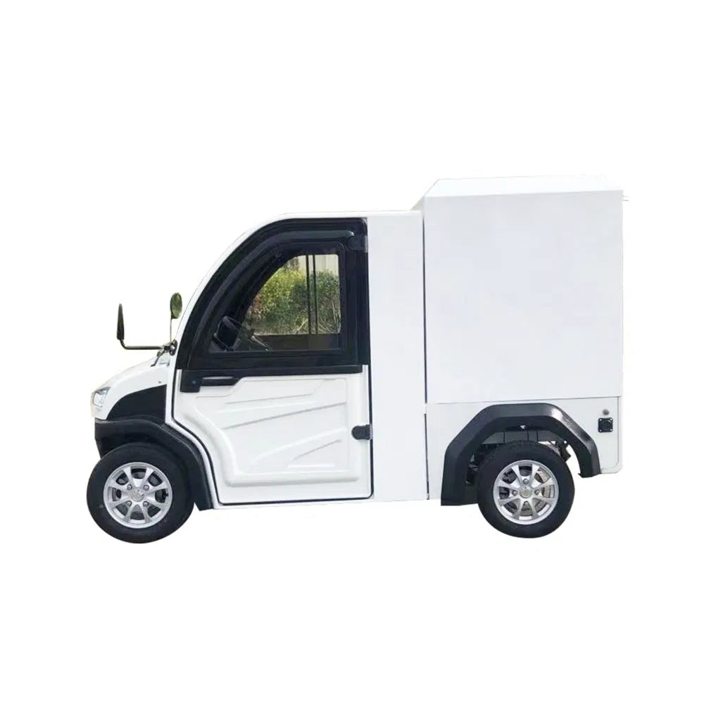ocean cartz side profile studio shot of a white enclosed electric delivery vehicle with a large, box-style rear cargo area, set against a white background. This two-seater commercial NEV or electric utility truck features an enclosed cab with black window frames, a black roof, and small, multispoke silver alloy wheels. The vehicle is designed for efficient last-mile delivery and urban logistics.