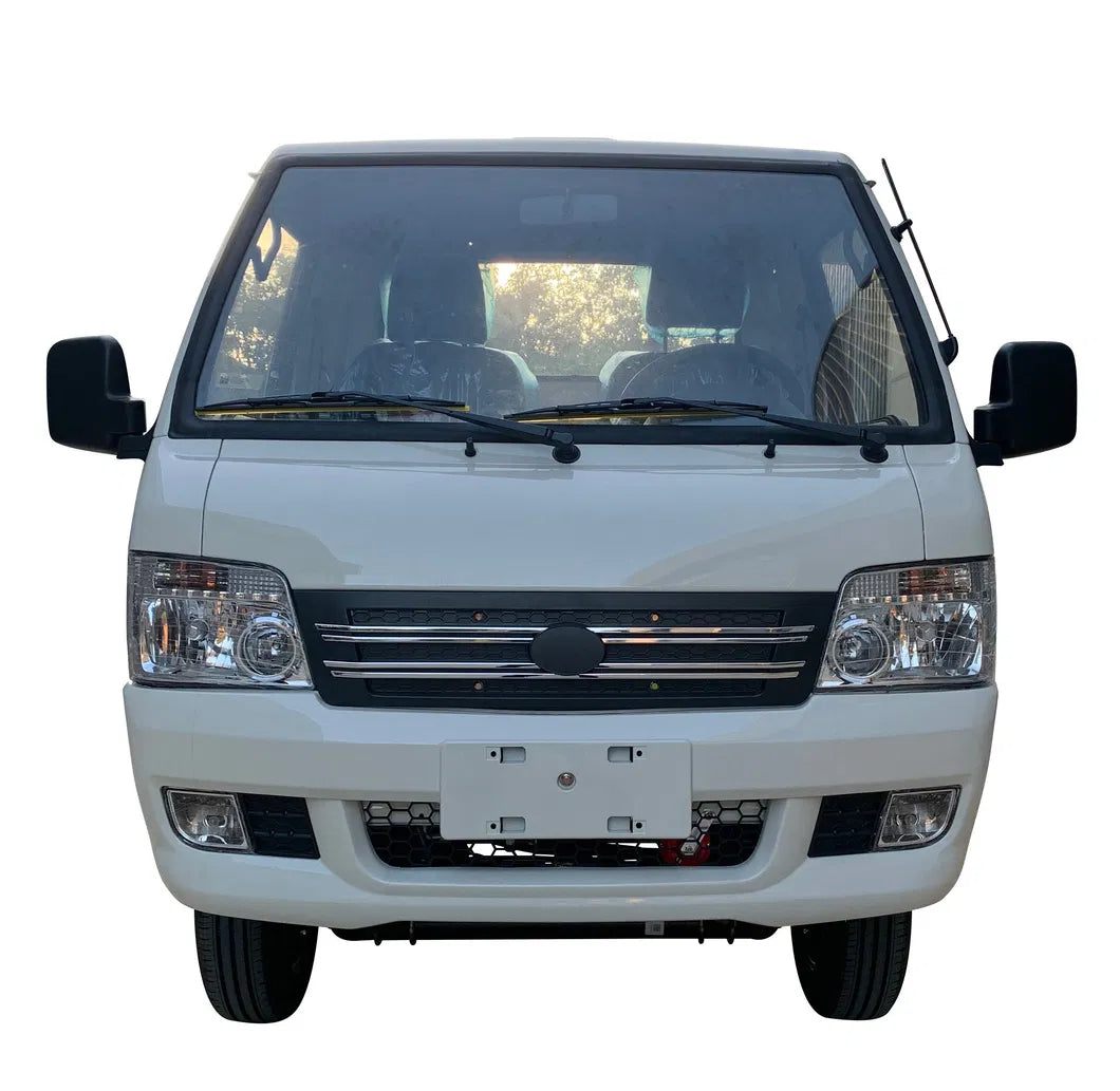 ocean cartz head-on studio shot of a white electric flatbed truck or mini truck with a single cab, set against a white background. This electric commercial utility vehicle features a large windshield, twin headlights, a black grille, and fog lights on the front bumper. The image highlights the professional, road-ready front design of the electric work truck.