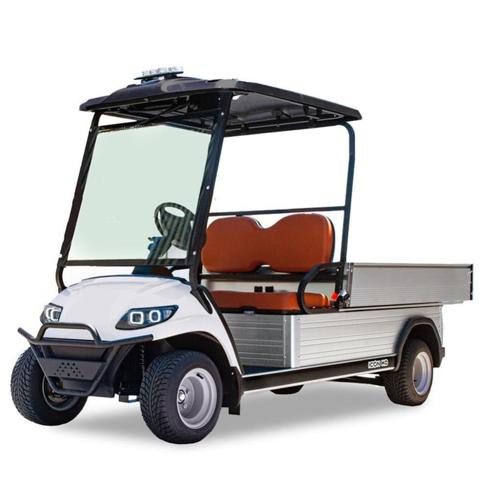ocean cartz three-quarter front studio shot of a white utility electric vehicle with a flat, silver aluminum cargo bed, set against a pure white background. This specialized electric work cart features a black roof, a black front brush guard, and brown two-seater upholstery. The utility golf cart has a wide windshield, all-terrain tires, and silver wheels, emphasizing its heavy-duty hauling capabilities.