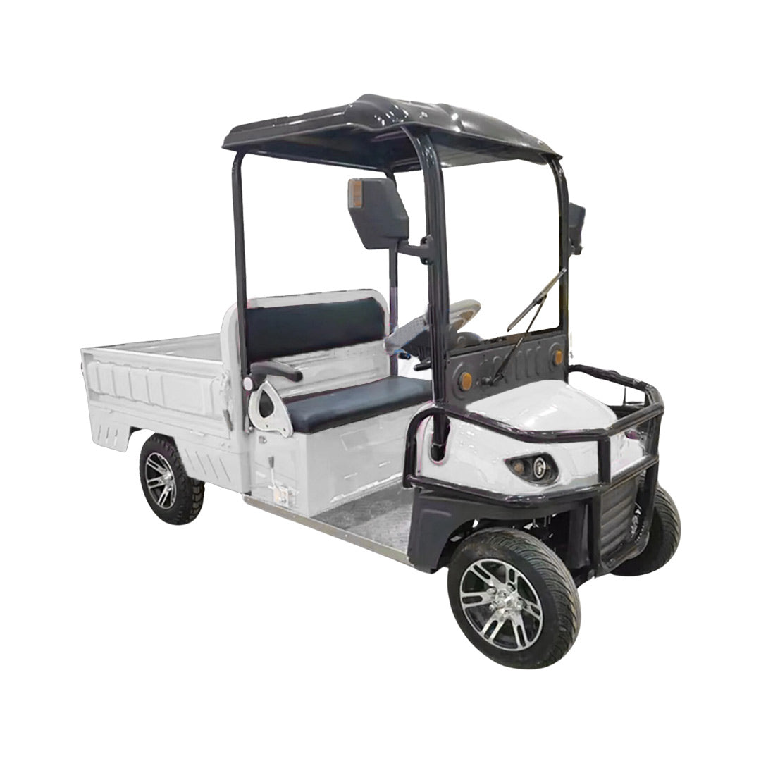 ocean cartz three-quarter front studio shot of a white utility electric vehicle with a short flatbed, set against a pure white background. This two-seater electric work cart features a black roof, black seats, a black front brush guard, and a small windshield with a wiper. The electric utility truck has custom silver alloy wheels and is designed for commercial hauling and property maintenance tasks.