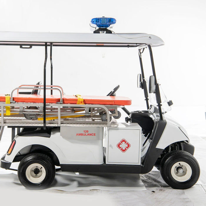 ocean cartz side view studio shot of a white electric ambulance golf cart or medical utility vehicle against a white background. This specialized emergency response cart features a stretcher with an orange pad and yellow straps mounted in the rear. It has a blue emergency light on the roof and a side storage cabinet marked "AMBULANCE" with a red cross logo, clearly indicating its function as a rescue golf cart.