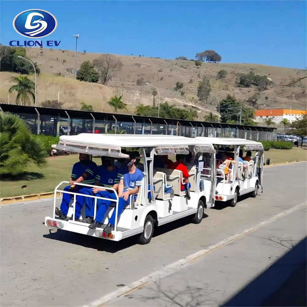 Electric sightseeing buses on a road with a scenic background