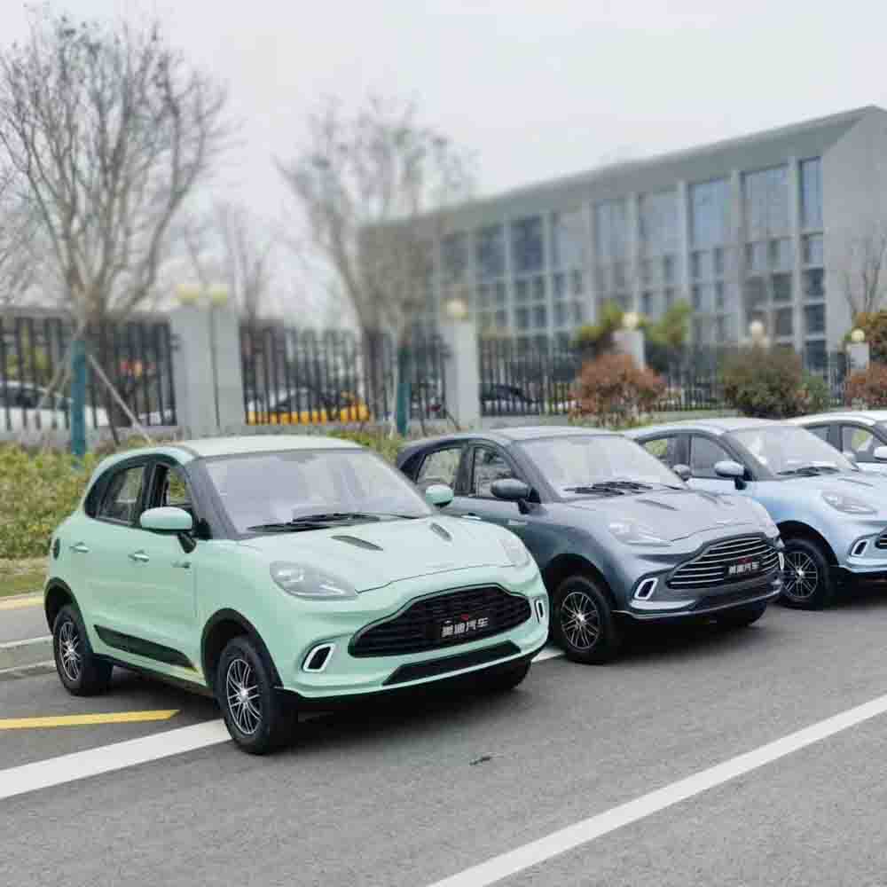 Row of cars parked in a lot with a building in the background