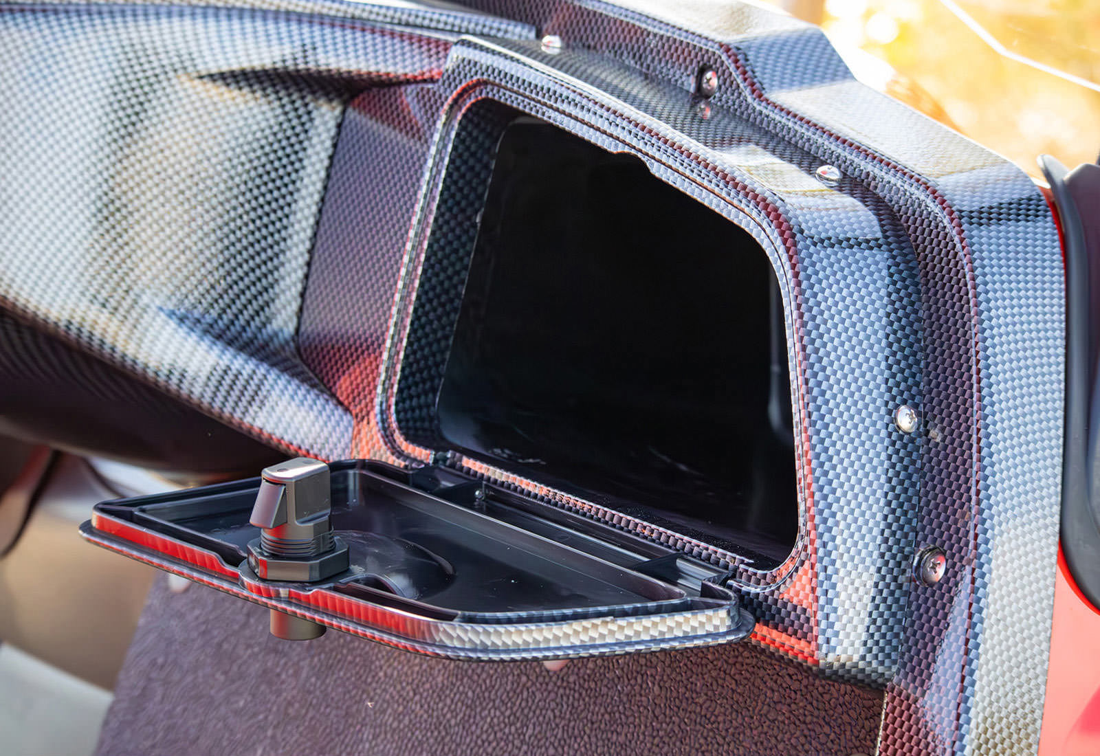 Carbon fiber car interior with a black console and visible stitching
