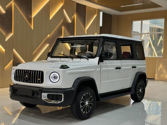 White Mercedes-Benz G-Class SUV in a showroom with geometric wall design