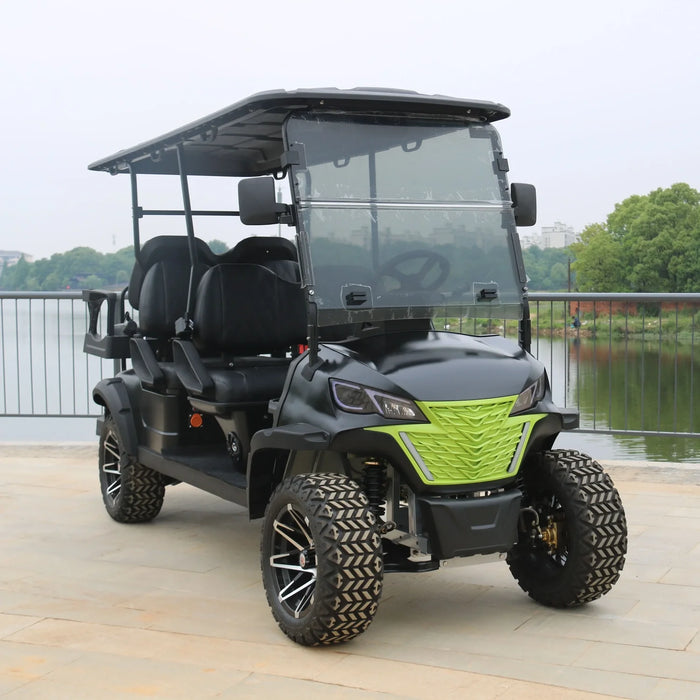 Black and green golf cart on a wooden deck with a lake and trees in the background