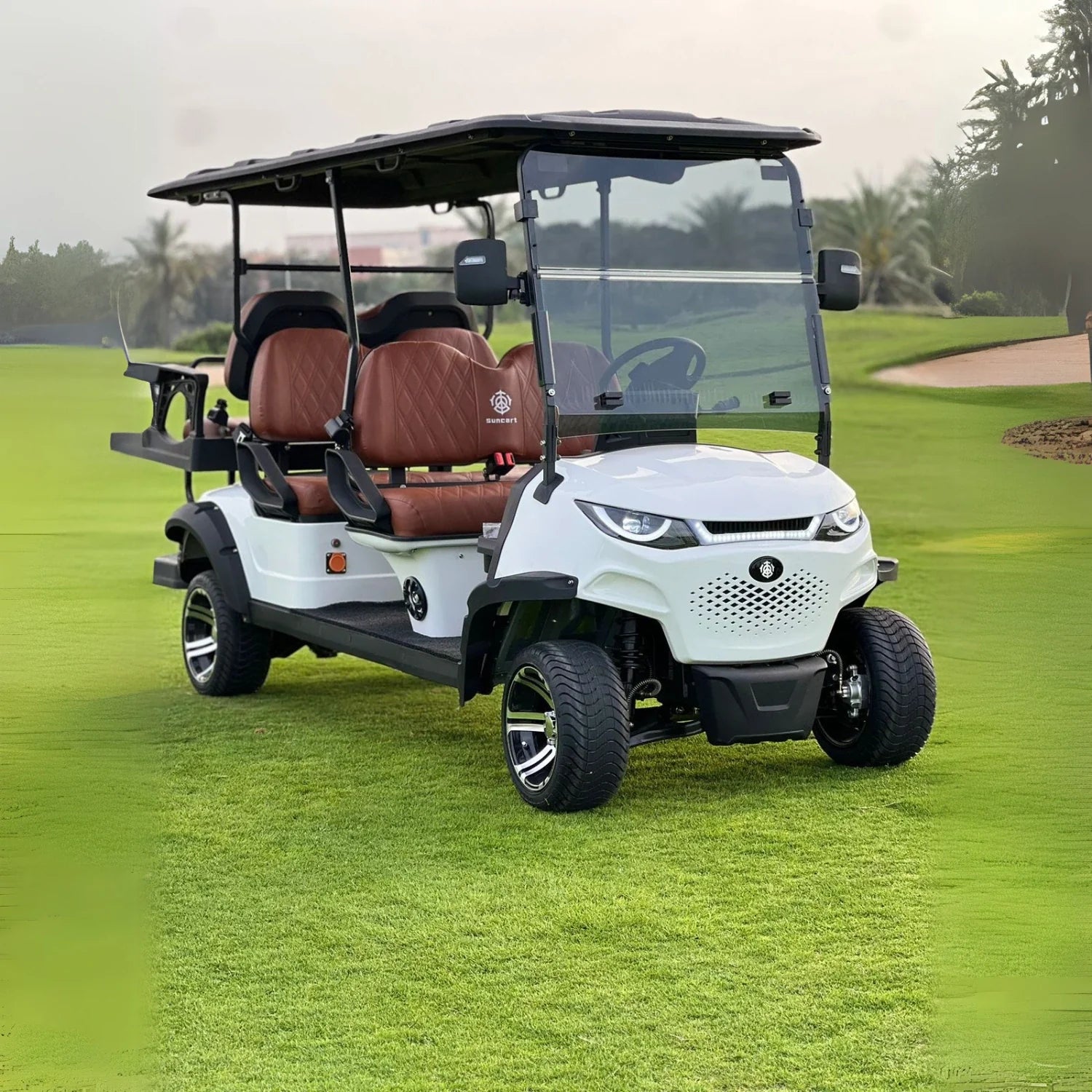Golf cart on a golf course with green grass and trees in the background