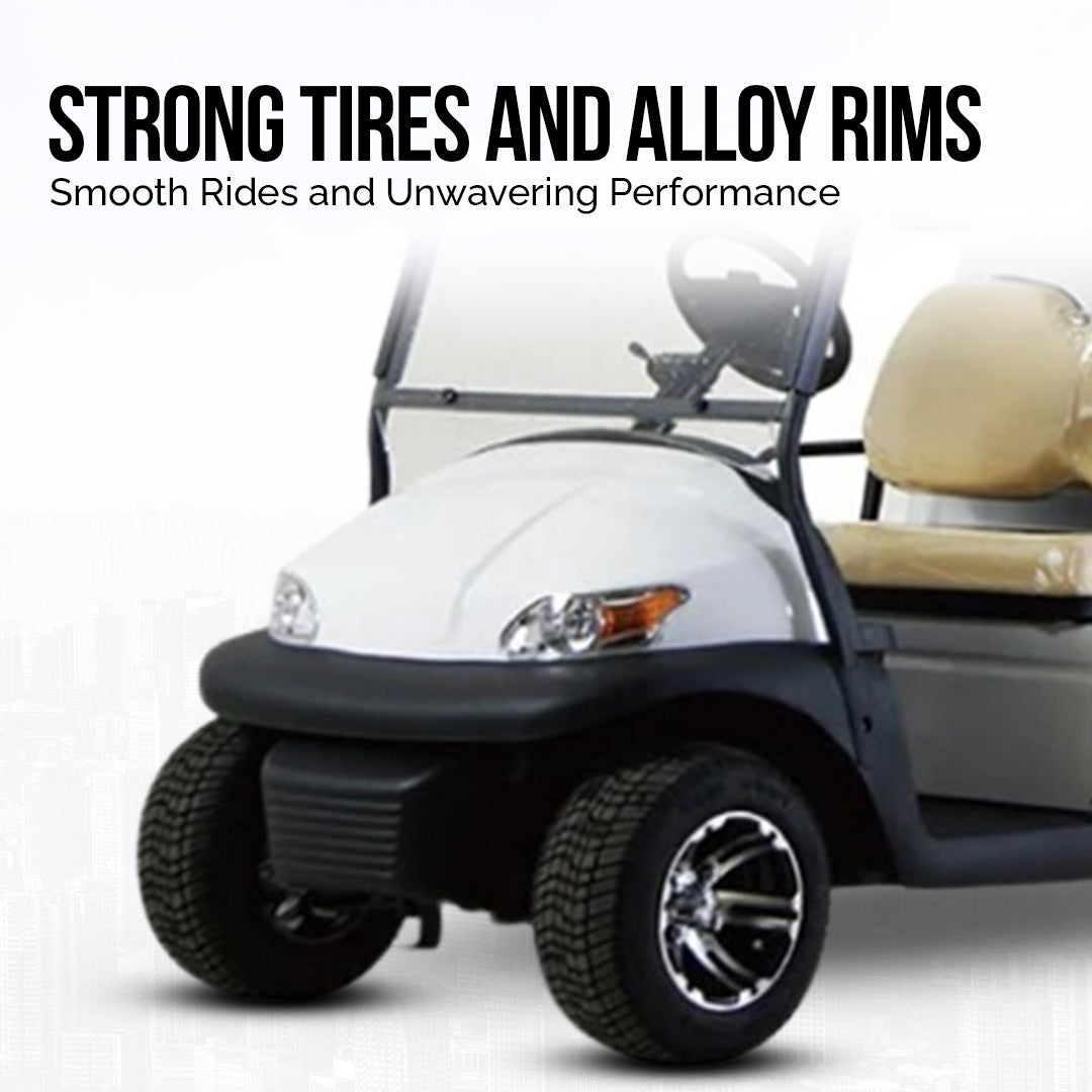 ocean cartz promotional image highlighting the strong tires and alloy rims of a white two-seater utility golf cart. The shot focuses on the front wheel and tire, which are fitted with a custom black and chrome rim. Text above the cart reads, "STRONG TIRES AND ALLOY RIMS" with the subtitle "Smooth Rides and Unwavering Performance," emphasizing the quality wheels and tires of this electric work cart.