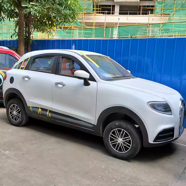 White SUV parked on a street with construction barriers in the background
