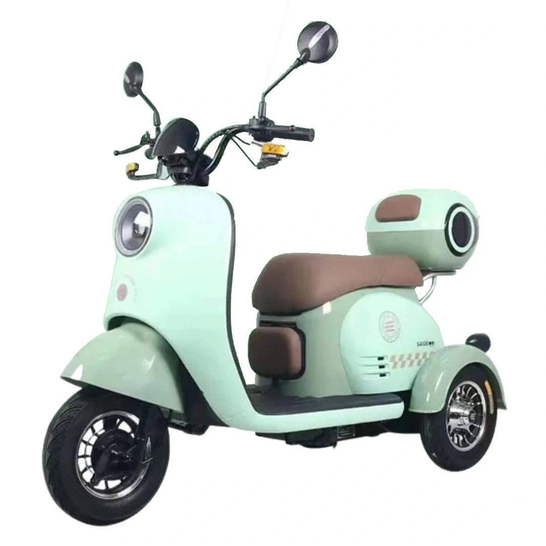 ocean cartz side view of a charming three wheel electric scooter in a light mint green color, featuring a brown vintage style seat, a large round headlight, and a matching rear storage box. This retro aesthetic mobility scooter is a stable and stylish personal transport vehicle for city cruising and fun, reliable travel.