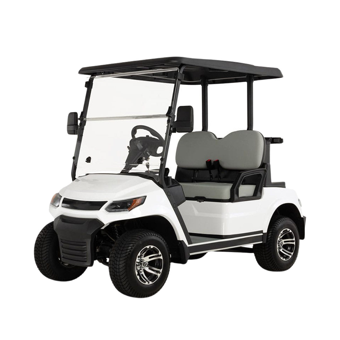 ocean cartz three-quarter front studio shot of a white four-seater golf cart with a black roof and a modern front design, set against a pure white background. This electric vehicle features light gray seats, a full windshield, and black lower trim. The golf cart is equipped with all-terrain tires and custom black and chrome wheels, highlighting its contemporary style and practicality.