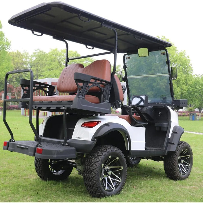 ocean cartz rear three-quarter view of a white six-seater golf cart with a black roof, parked on grass. This off-road electric vehicle is a lifted utility cart featuring brown diamond-stitched leather seats and a robust rear flip seat. It is equipped with thick, knobby all-terrain tires on custom black and silver wheels, clearly showing the rear suspension and black fender flares.