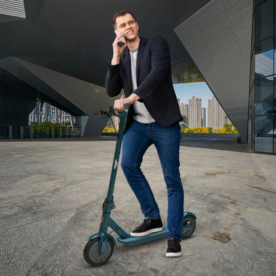 Man standing on a teal scooter in an urban setting