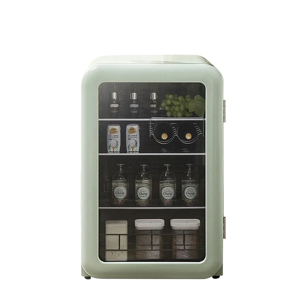 Small refrigerator with glass door displaying various items on a white background