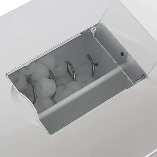 Close-up of a white appliance with a transparent door showing internal components.