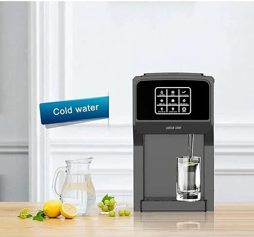 Water dispenser on a wooden surface with a glass of water and lemons in the background.