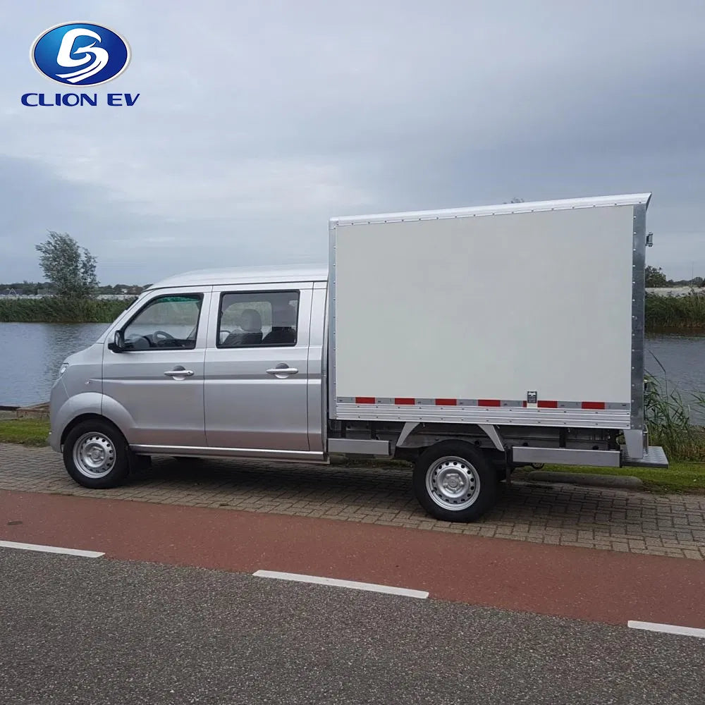 Silver electric van with a trailer on a road near a body of water, featuring the CLION EV logo.