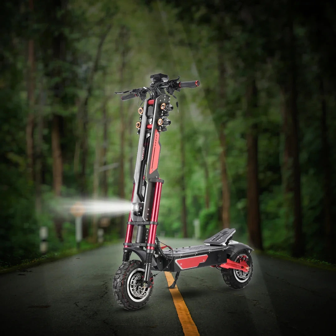 Red and black electric scooter on a road with a forest background