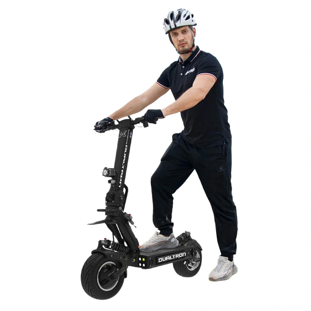 Person riding a black electric scooter with 'Dualtron' branding on a white background