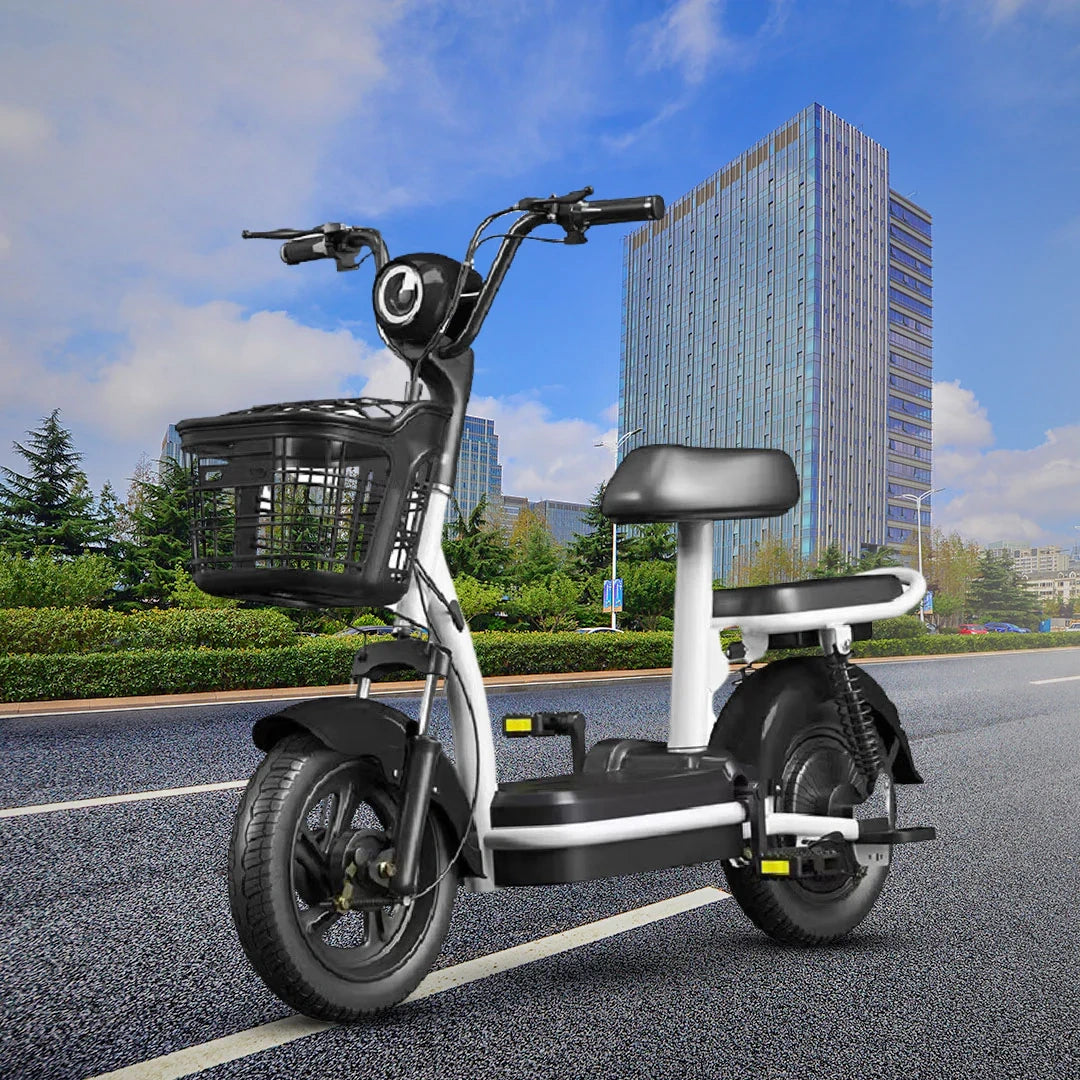 Electric scooter with a basket on a road with a tall building in the background