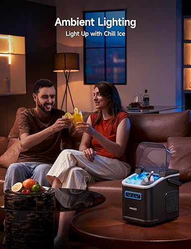 Two people sitting on a couch in a dimly lit room with a Chill Ice cooler on a table.