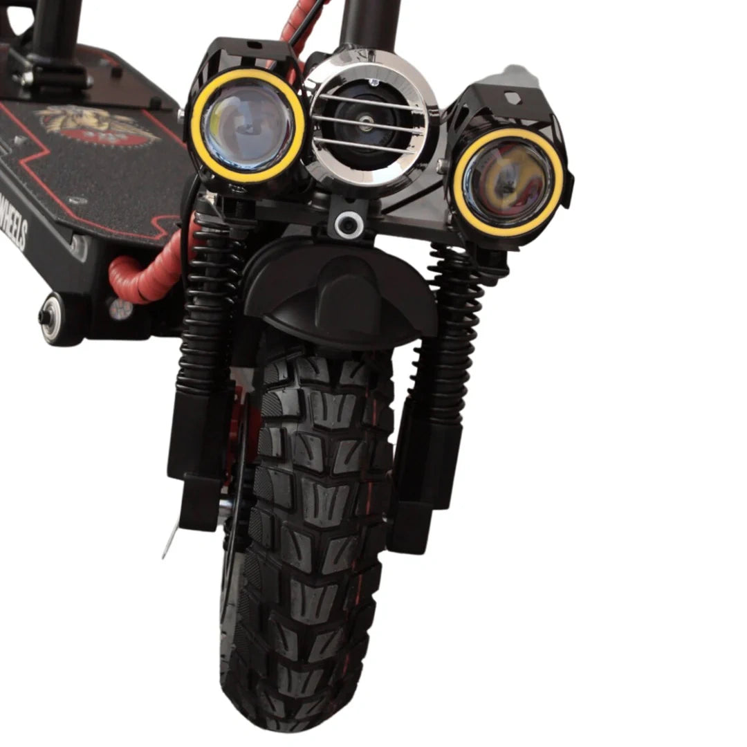 Close-up of a scooter with off-road tires and additional lighting equipment on a white background
