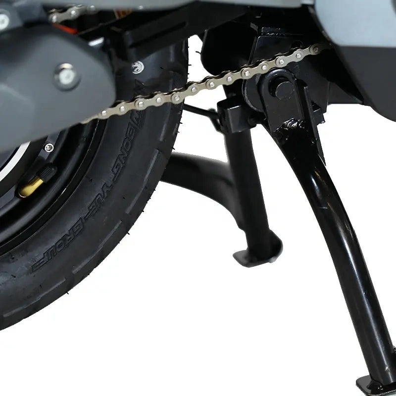 Close-up of a motorcycle chain and wheel on a white background