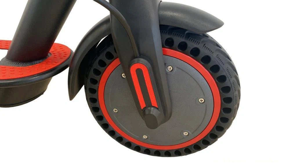 Close-up of a scooter wheel with red accents on a white background